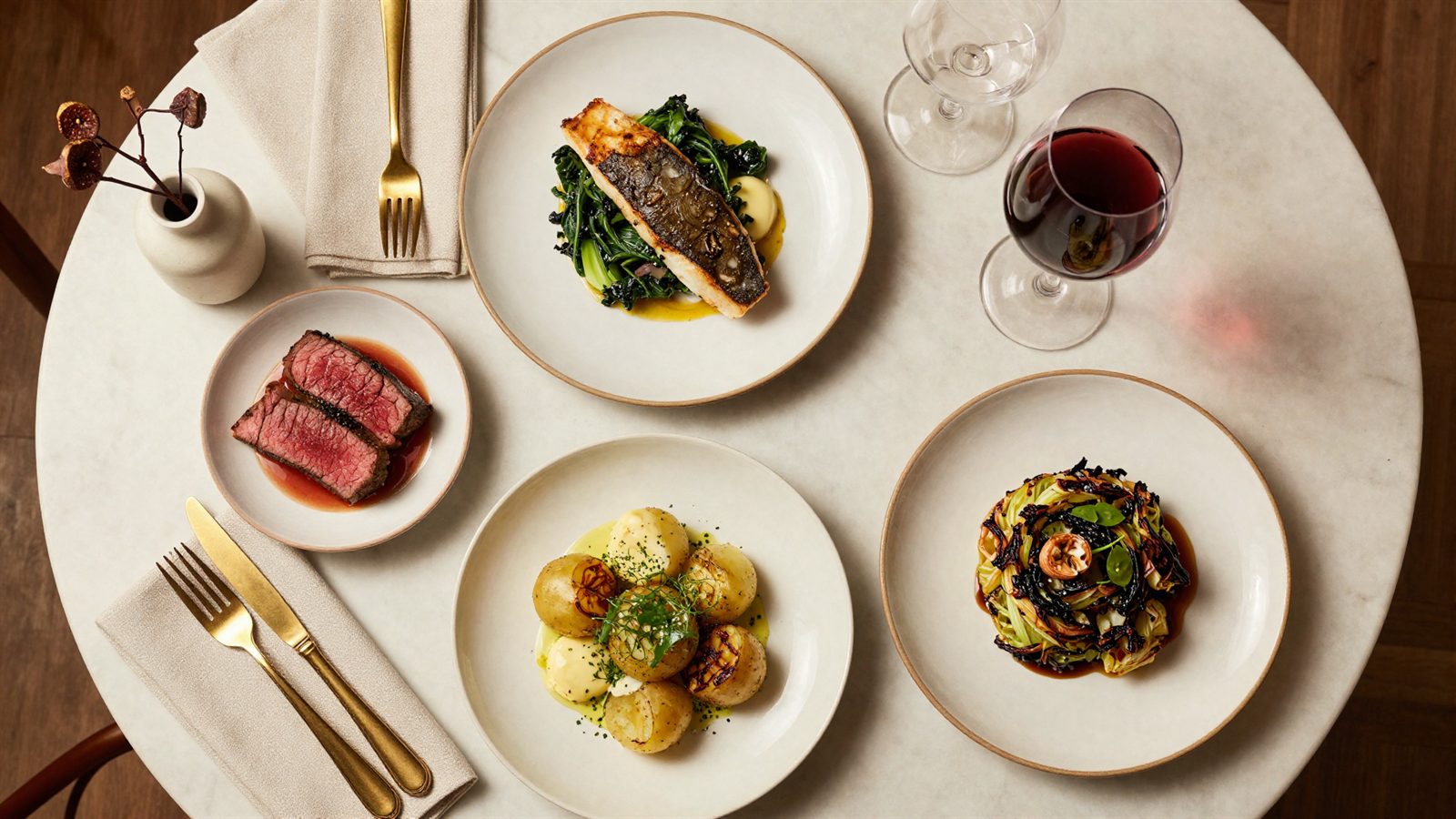 An overhead spread of dishes on a marble table at The Copper Fig